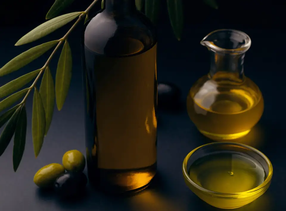 Olive oil bottle, cruet and olives