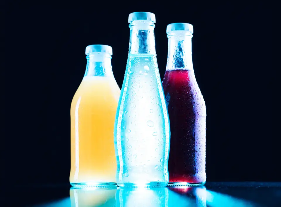 Unbranded glass bottles of juice and water