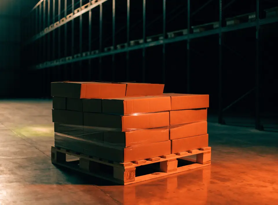 Pallet of food boxes wrapped in stretch film inside a warehouse